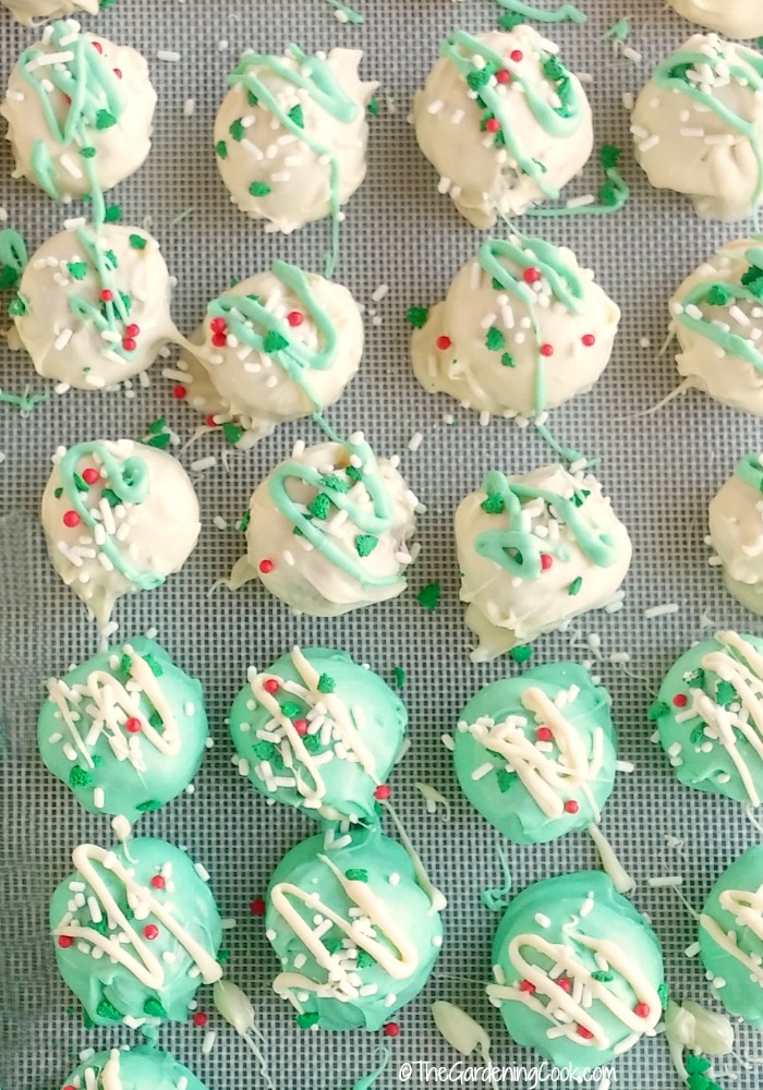 Chocolate peppermint truffles with icing on a silicone mat.