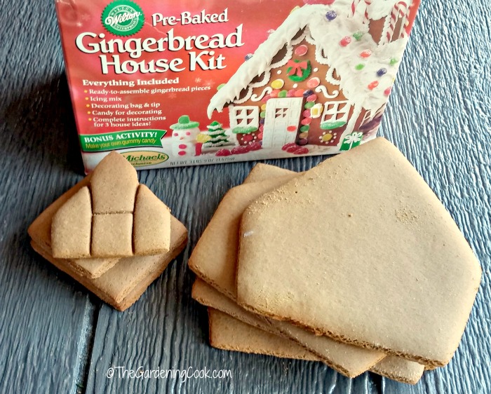 Gingerbread house kit in a box and pieces of formed gingerbread.