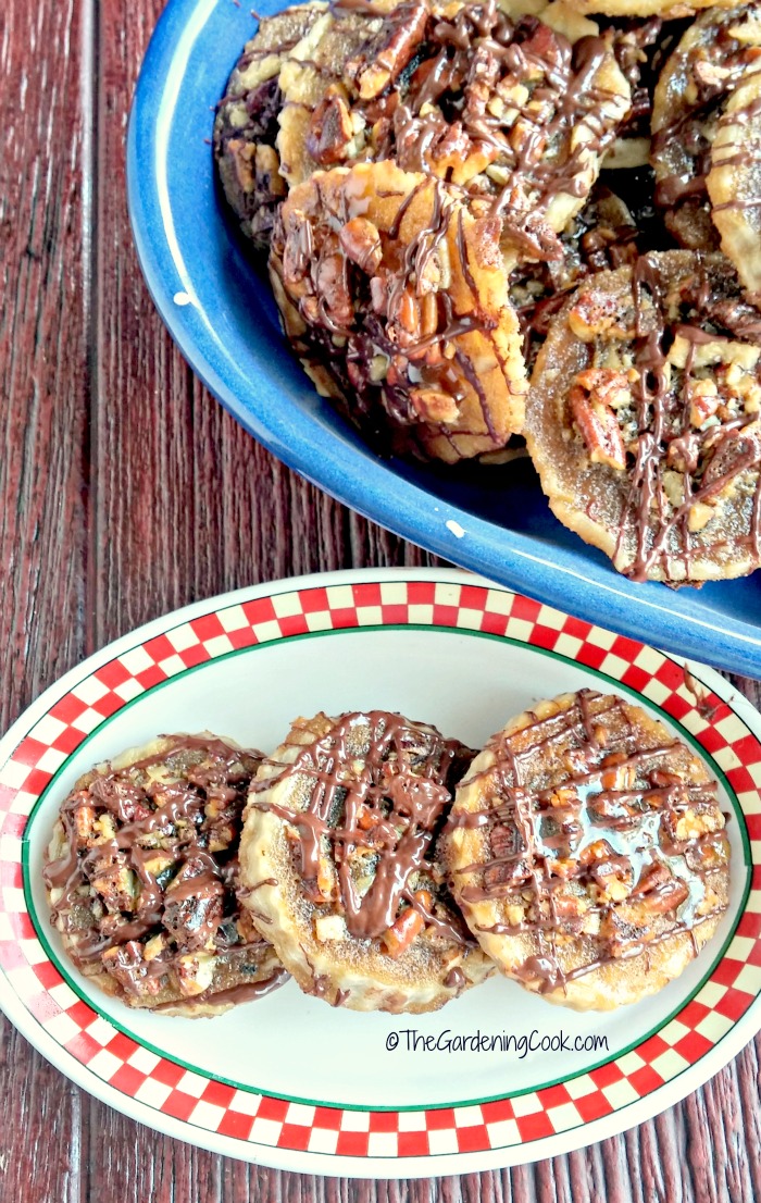 Pecan pie cookies on a checked plate and bowl of cookies.