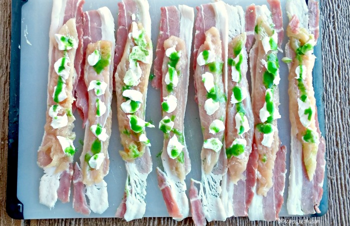 Chicken tender strips with cream cheese, bacon and hot sauce.