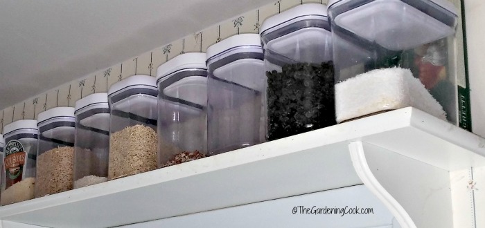 Oxo containters on a top shelf keep dry goods out of the way and save on pantry space