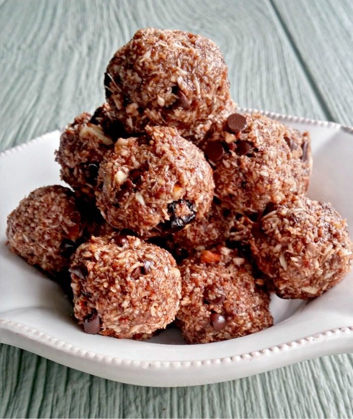 Bowl of energy bites with text reading Paleo chocolate hazelnut energy bites.