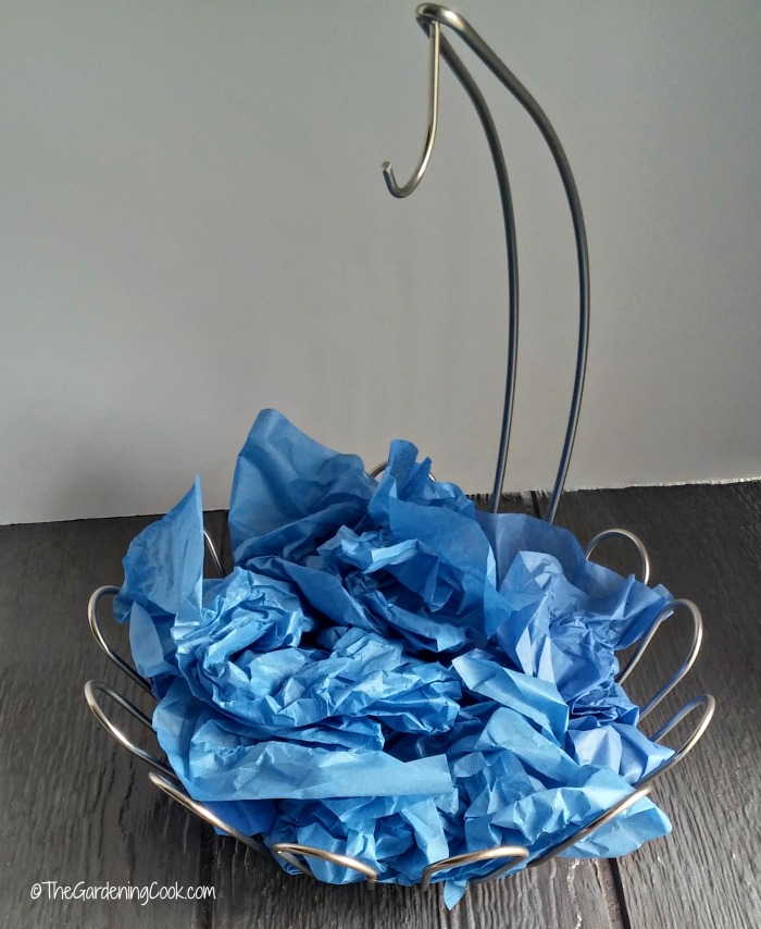 Add height to the basket with crumpled tissue paper
