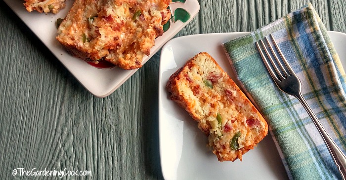 Bacon jalapeno cheese bread on a plate with a fork and napkin.