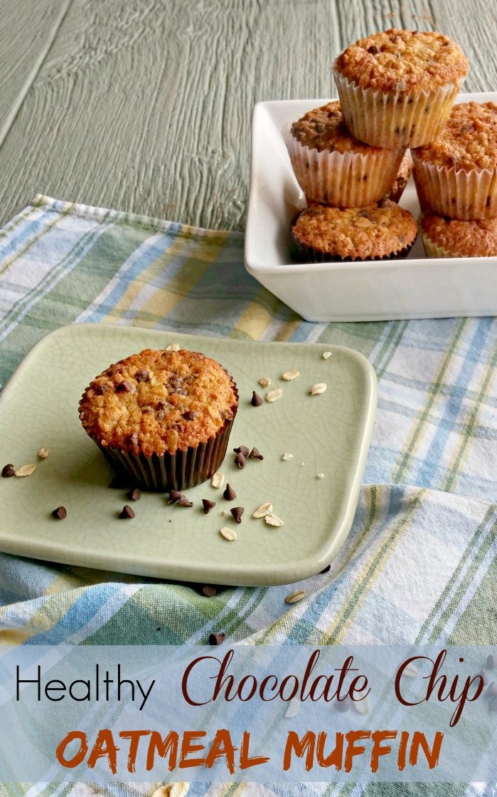 Muffin on a plate near a bowl of muffins and blue checked napkin with words reading Healthy Chocolate Chip Oatmeal Muffin.