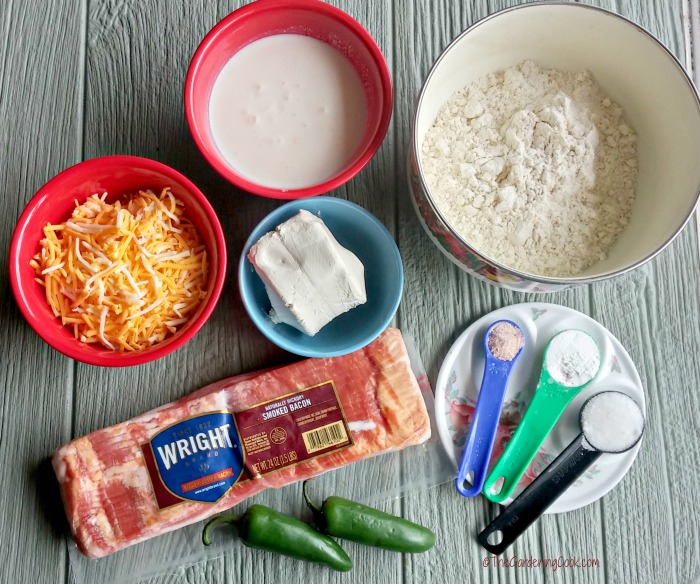 cheese, cream cheese, bacon, spices, flour, and peppers on a wooden board. 