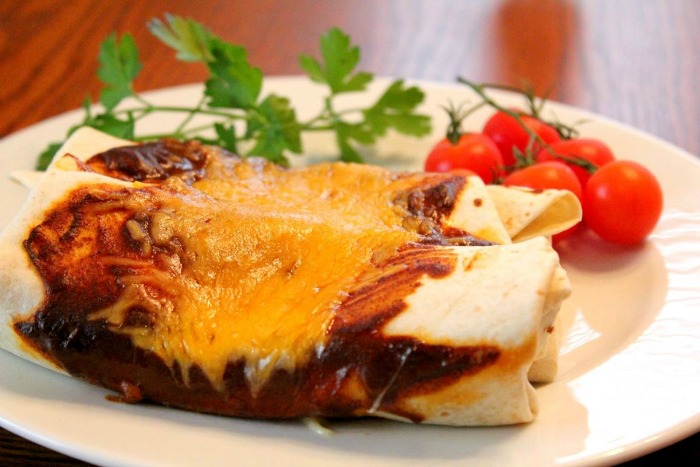 Chicken enchiladas is a great main course for our Cinco de Mayo progressive dinner party from terristeffes.com