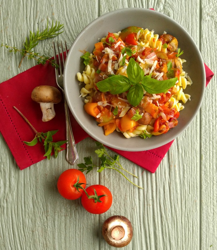 Roasted Tomato Vegetable Marinara Sauce with Pasta with fresh mushrooms and tomatoes, a fork and red napkin.