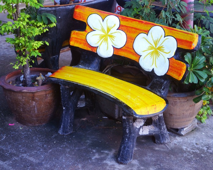 Garden bench with a flowered back