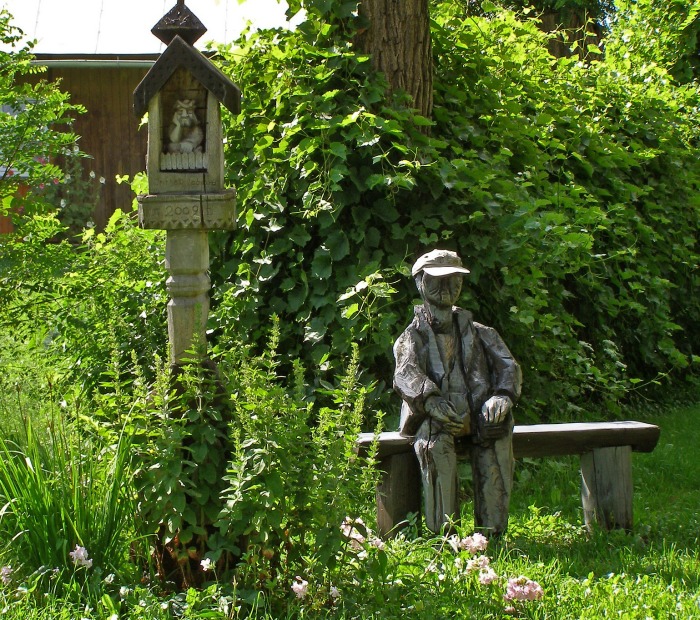 Carved figure on a log garden bench