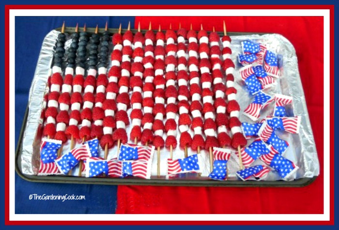 Patriotic Fruit Flag made of blueberries, raspberries, mini marshmallows and patriotic mint packages.