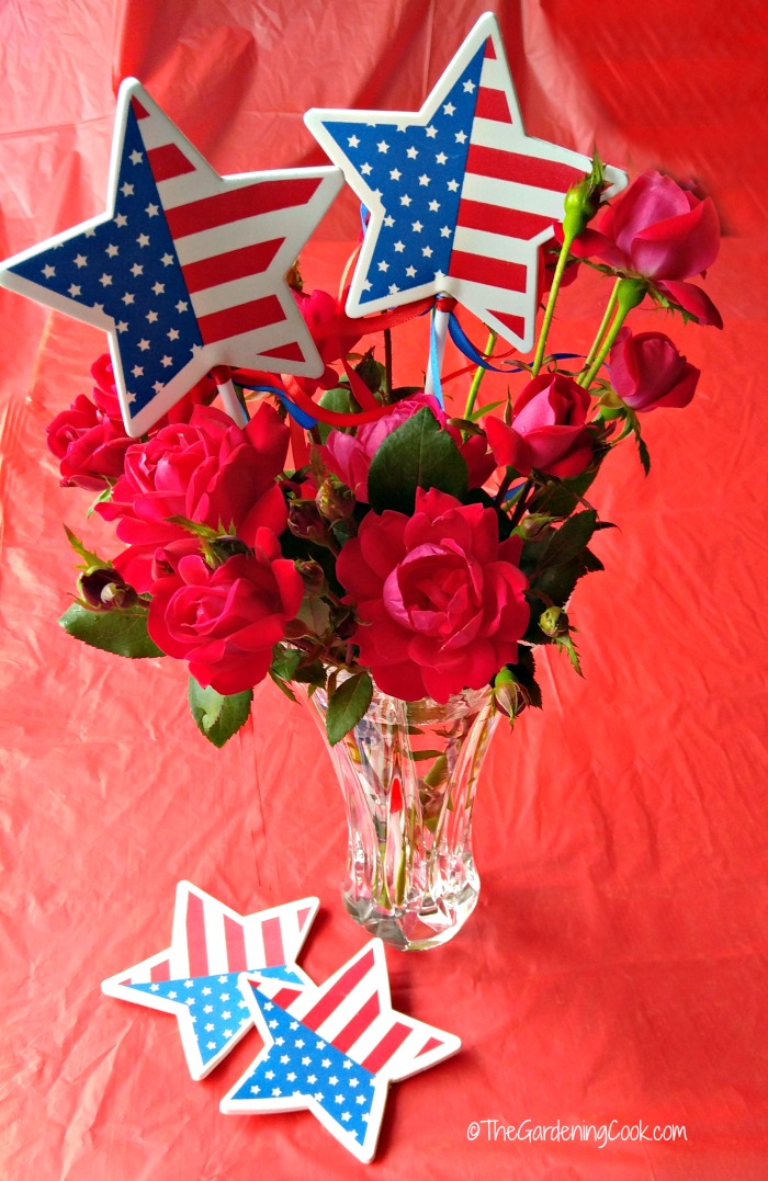 Patriotic Rose Vase decor with star flags on a red tablecloth.