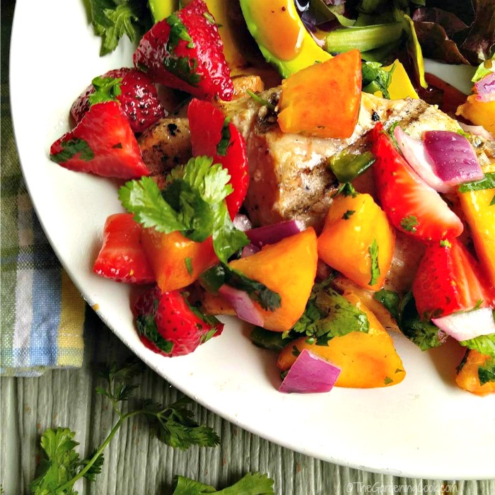 Close up of grilled pork with strawberry peach salsa