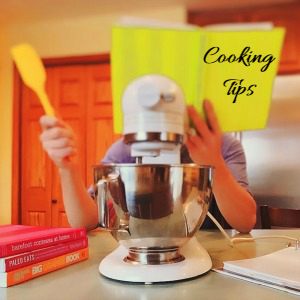 Woman with a mixer and book that says Cooking Tips.