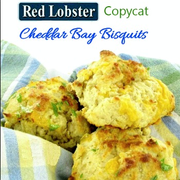 Biscuits in a bowl with a blue checked cloth and words Red Lobster copycat cheddar bay biscuits.