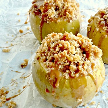 Baked caramel apples on parchment paper.