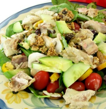 Salad recipe with granola and chicken on a blue plate.
