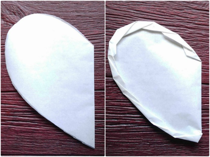 Making a heart shaped parchment paper parcel.