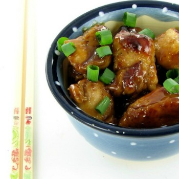 Blue bowl and chop sticks with a Chinese recipe and spring onions.