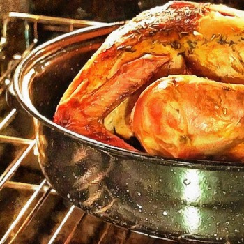 Roasting pan filled with a large whole turkey.