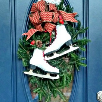 Holiday decoration for Christmas - skates on a blue door with a red bow.