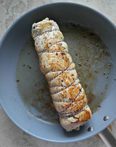 Sear the rolled pork to make baking time less