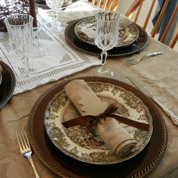 Brown and beige tablescape with crystal goblets.