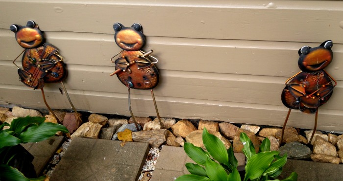 Creative Metal Yard Art Frogs add a whimsical greeting to the front door of the cottage