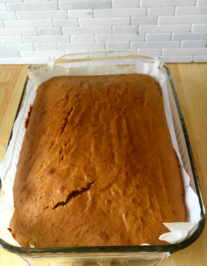 Pumpkin spice cake cooling in a glass pan.