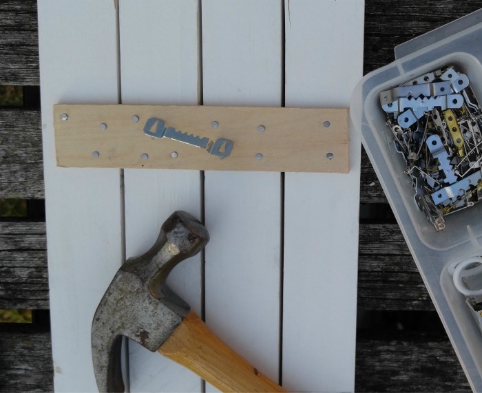Attach a metal saw tooth picture hanger in place.