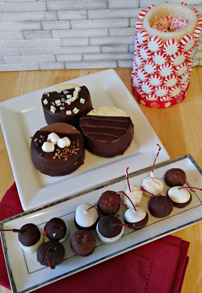 Plates of truffles and sweet treats with a peppermint covered candle.