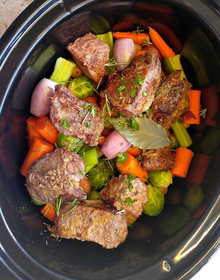 Add the browned beef and spices on top of the vegetables