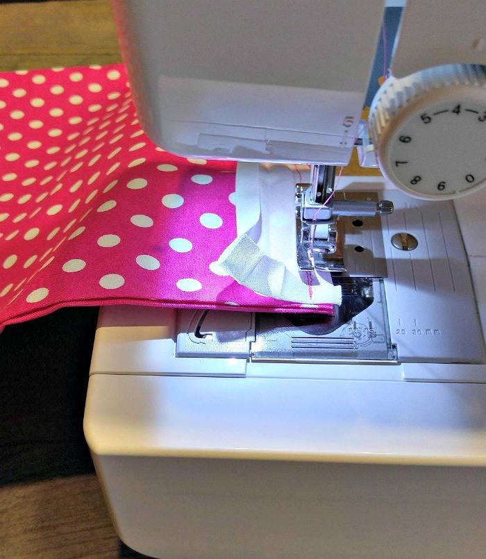 Stitching bias tape in place ion a sewing machine.