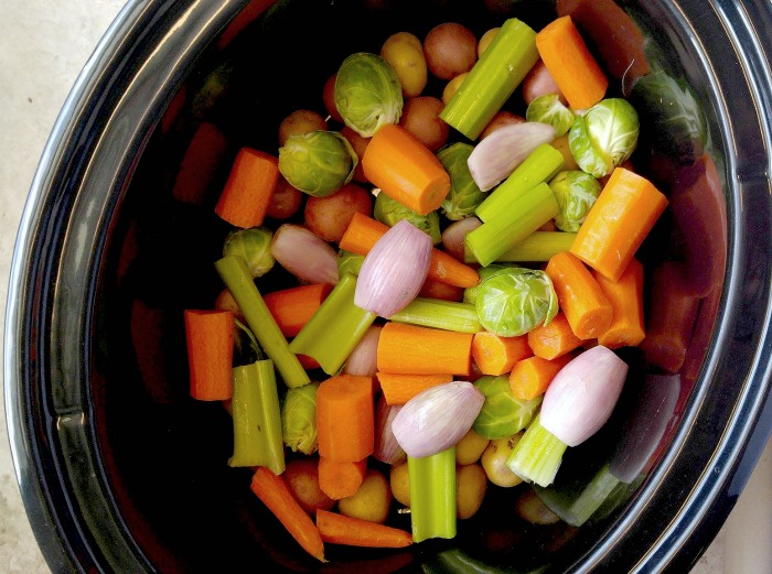 Place the vegetables in the bottom of the crock pot