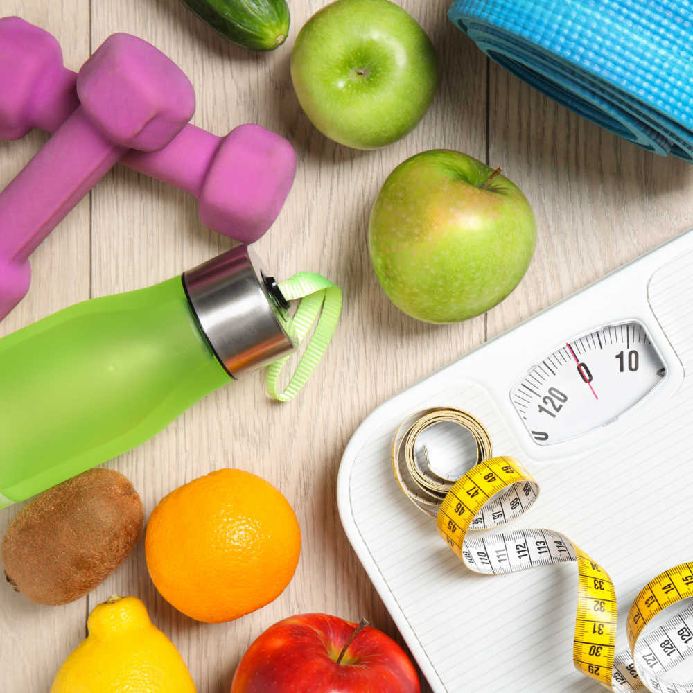 Fruit, juice, and scales with measuring tape.