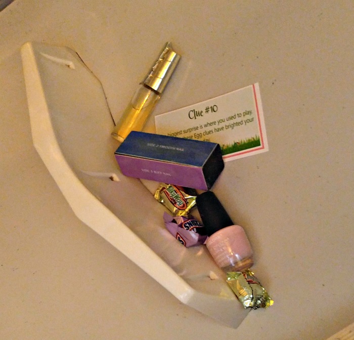 Nail polish with nail buffer, candy and clue.