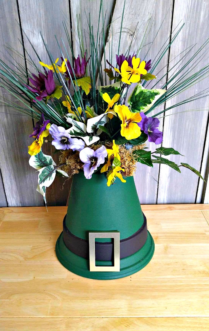 St. Patrick's Day Centerpiece with flowers on top of clay pots shaped like a leprechaun hat.