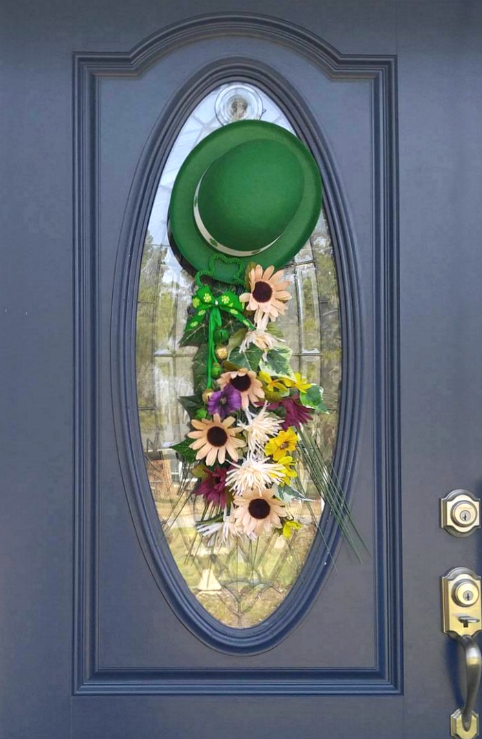 St. Patrick's Day Door Swag with leprechaun hat and silk flowers.