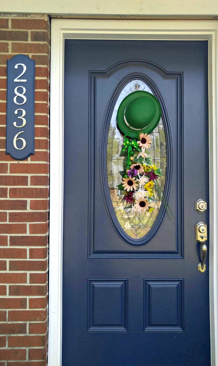 St. Patrick's Day Door Swag on a blue door of a brick house with numbers 2836.