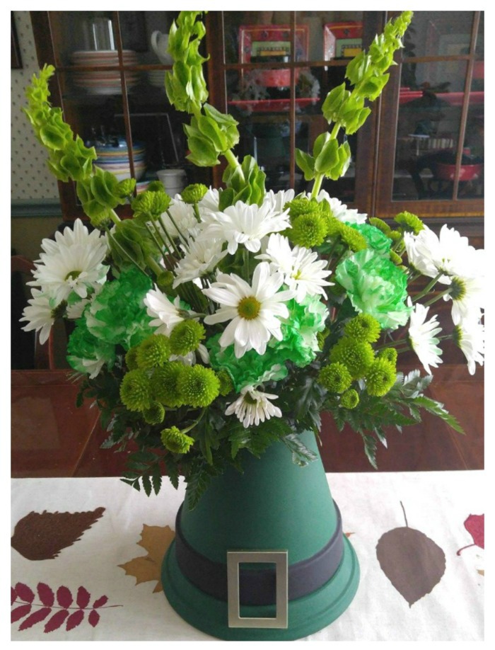 St. Patricks' Day Hat Centerpiece made from clay pots in the shape of a hat and fresh flowes.