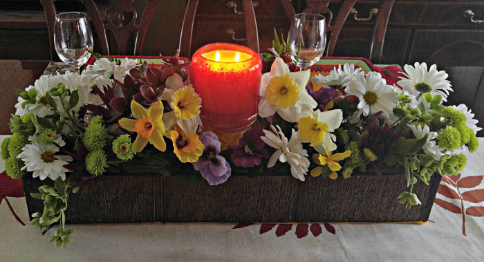 Candle centerpiece with fresh flowers