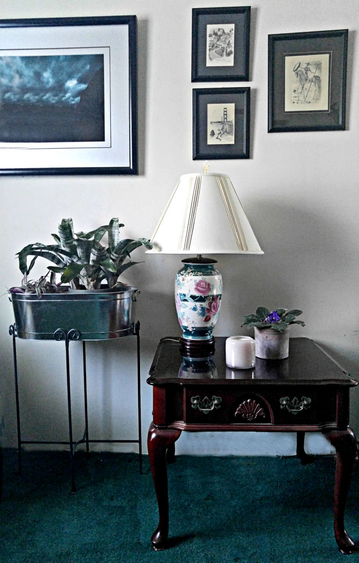 A single candle on a bare table can coordinate with the lamp and planter for instant decor.