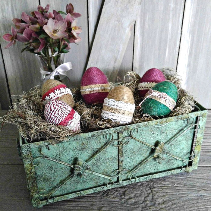 Bin of rope wrapped eggs with burlap ribbon
