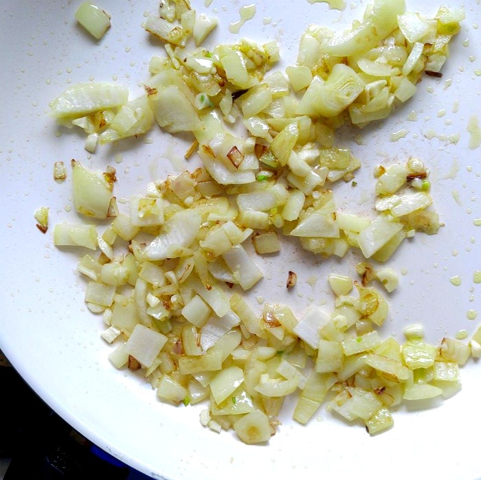 onions and garlic in a frying pan Cooked onions and garlic