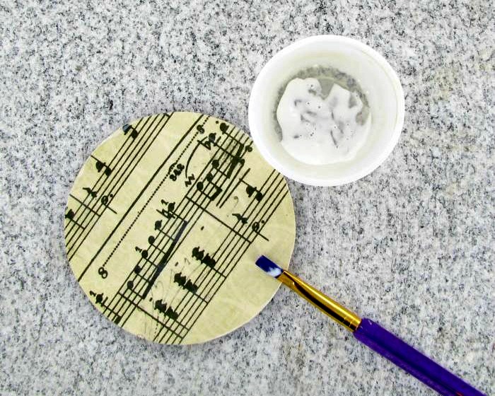 Adding Mod Podge to the top of the sheet music