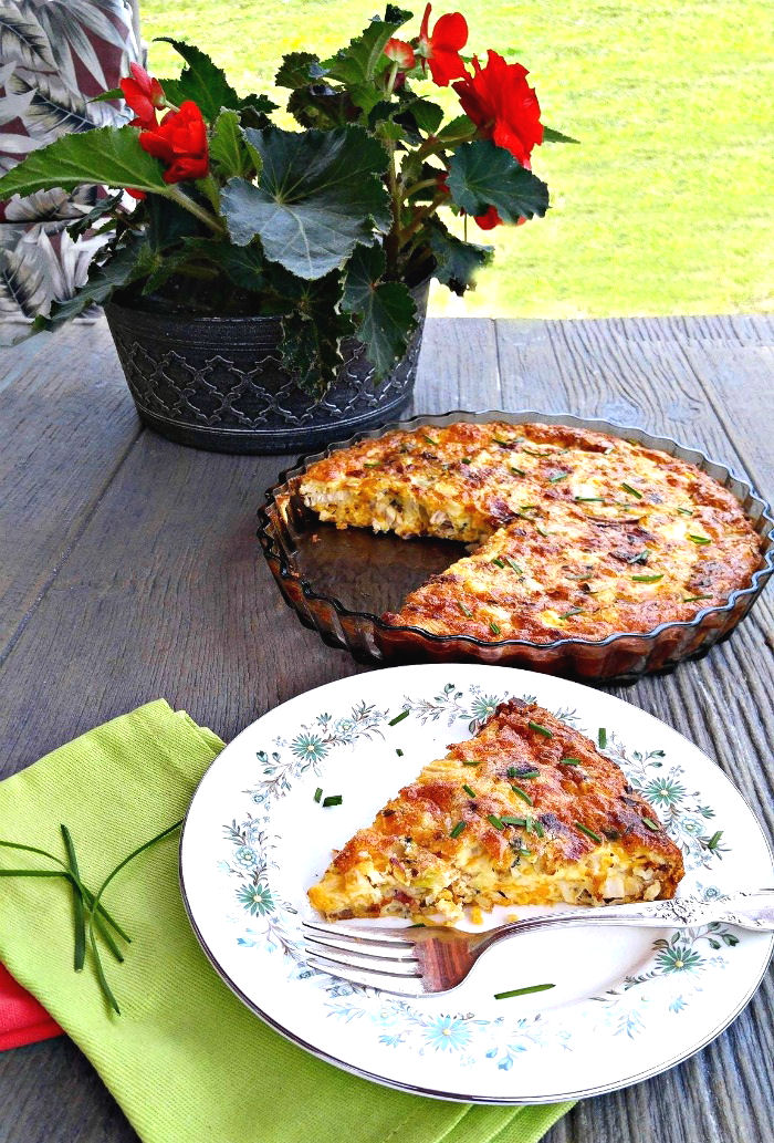 Begonias on a patio table with cooked quiche Serve this chicken quiche no pasty recipe. for Mother's Day Brunch