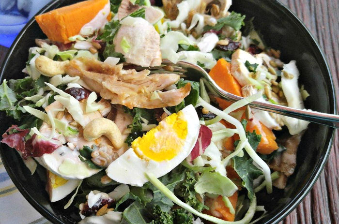 Taking a bite of this chicken-sunflower-kale-salad