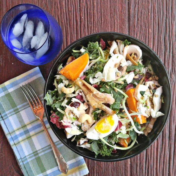 Yams, hard boiled eggs and cashews add a lot to the sunflower kale salad