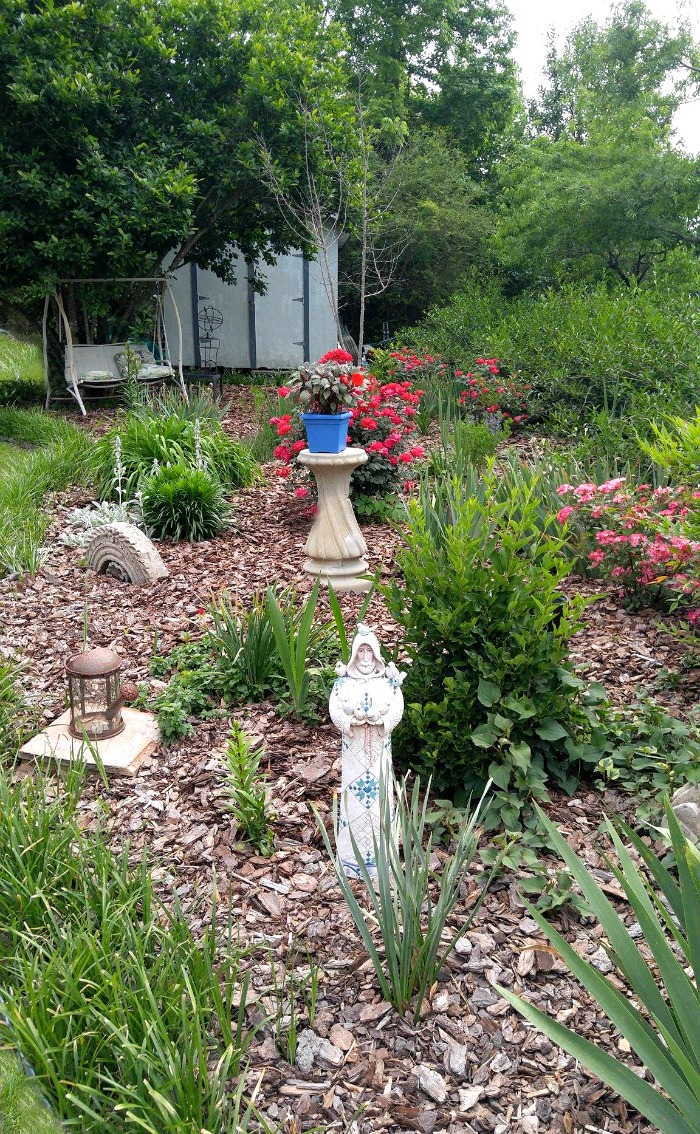 Summer garden bed and statue