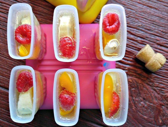 Add champagne over fruit in the popsicle molds